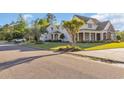 Attractive home with a well-kept lawn, lush landscaping, and a charming front porch at 107 Long Bay Golf Pl., Longs, SC 29568