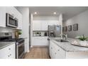 Well-equipped kitchen featuring stainless steel appliances, granite counters, sleek cabinets, and modern hardware at 1154 Silver Perch Place, Sunset Beach, NC 28468