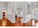Elegant foyer boasts hardwood floors, wainscoting, and a decorative chandelier at 120 Whitemarsh Ct., Murrells Inlet, SC 29576