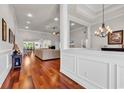 Spacious living room featuring hardwood floors, a large sectional, and bright, natural lighting at 120 Whitemarsh Ct., Murrells Inlet, SC 29576