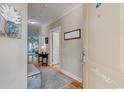 Inviting foyer with hardwood floors and a welcome sign on the front door at 128 Puffin Dr. # 1E, Pawleys Island, SC 29585