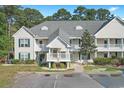 Attractive condominium building with balconies, landscaping, and adjacent parking at 148 Scotch Broom Dr. # 201, Little River, SC 29566