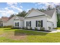 Exterior showing well-maintained lawn and white siding with black shutters at 1500 Sunmeadow Dr., Conway, SC 29526