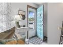 Bright entryway with white furnishings, decor, and a teal door at 1502 Yaupon Dr. # A-1, Myrtle Beach, SC 29577