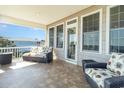 Comfortable outdoor seating area on covered balcony with tiled flooring, ideal for relaxation at 1718 Perrin Dr., North Myrtle Beach, SC 29582