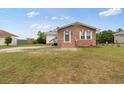 Well-maintained brick home with a cozy front porch and freshly mowed lawn at 175 Cypress Ln., Little River, SC 29566