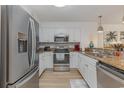 Bright kitchen boasts granite counters, white cabinets, and stainless steel appliances for a modern and stylish cooking experience at 1819 N Ocean Blvd. # 5014, North Myrtle Beach, SC 29582