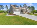 Beautiful home with a manicured lawn, ample parking, and charming curb appeal at 211 Blackwater Dr., Murrells Inlet, SC 29576