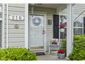 Close up shot of home's front door that includes a wreath and decorative chair at 216 Whitchurch St., Murrells Inlet, SC 29576