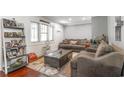 Cozy living room featuring hardwood floors, comfortable seating, and a window with blind coverings at 218 Busbee St., Conway, SC 29526