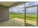 View from screened-in back porch overlooking fenced-in yard and a tranquil lake at 227 Carmello Circle, Conway, SC 29526