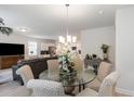 Open-concept dining room with a glass table and views into the living room and kitchen at 238 Juniata Loop, Little River, SC 29566