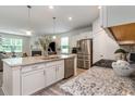 Modern kitchen with granite countertops, stainless steel appliances, and white cabinetry at 238 Juniata Loop, Little River, SC 29566
