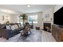 Inviting living room featuring a cozy fireplace, plush leather sofa, and plenty of natural light at 238 Juniata Loop, Little River, SC 29566