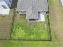 Aerial view of backyard featuring a large, well-maintained lawn, patio, and a full fence at 239 Calhoun Falls Dr., Myrtle Beach, SC 29579