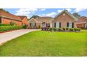 Well-manicured front yard with lush green grass and thoughtfully arranged shrubbery enhances curb appeal at 2617 Willet Cove, Conway, SC 29526