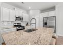 Well-equipped kitchen features granite countertops, stainless steel appliances, and white cabinets for a modern look at 2620 Blue Crane Circle # 103, Myrtle Beach, SC 29577