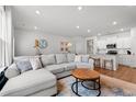 Spacious living room with an open floor plan, modern sectional sofa, and a view into the bright kitchen at 2620 Blue Crane Circle # 103, Myrtle Beach, SC 29577