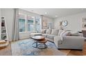 Bright living room with large windows, comfortable sectional sofa, and stylish round coffee tables on a colorful rug at 2620 Blue Crane Circle # 103, Myrtle Beach, SC 29577