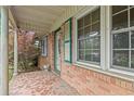 Close up of front porch and entry door of brick home with tile flooring at 2858 Daisy Rd., Loris, SC 29569
