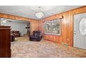 Cozy living room with wood paneling, traditional furniture, and a ceiling fan at 2858 Daisy Rd., Loris, SC 29569