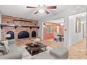 Cozy living room with a large brick fireplace, neutral furniture, and classic details at 2858 Daisy Rd., Loris, SC 29569