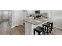 Bright kitchen with granite countertops, island with seating, and stainless steel appliances at 332 Bayou Loop # Lot 69, Surfside Beach, SC 29575