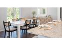 Elegant dining room featuring a modern table and chairs with a decorative sideboard at 378 Ladyfish Loop, Sunset Beach, NC 28468