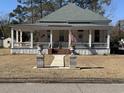 An elegant home featuring a well-manicured lawn and charming front porch at 402 Gibson St., Marion, SC 29571