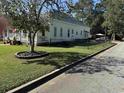 A side view of the property showcasing well-maintained lawn with street view at 402 Gibson St., Marion, SC 29571