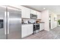 Modern kitchen featuring stainless steel appliances, granite countertops, and wood-look floors at 409 Flank St., Myrtle Beach, SC 29588