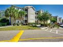 Exterior of condominium building featuring balconies, beautiful landscaping, and reserved parking spaces at 4215 Coquina Harbour Dr. # D -2, Little River, SC 29566