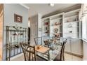 Bright dining area featuring built-in shelving, neutral wall color, and a glass-top table with seating for four at 4215 Coquina Harbour Dr. # D -2, Little River, SC 29566