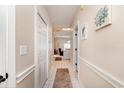 Neutral hallway featuring white tile flooring and access to other rooms at 4709 Wild Iris Dr. # 101, Myrtle Beach, SC 29577