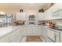 Bright kitchen featuring white cabinets, countertops, and appliances at 4729 Wild Iris Dr. # 104, Myrtle Beach, SC 29577