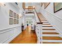 Grand foyer with beautiful hardwood floors, staircase, and elegant decor, creating a warm welcome at 486 Lantana Circle, Georgetown, SC 29440