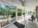 Inviting front porch with comfortable rocking chairs and a hanging swing at 486 Lantana Circle, Georgetown, SC 29440