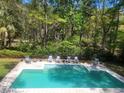 Sparkling pool surrounded by a patio and lush greenery, perfect for relaxation and outdoor entertainment at 486 Lantana Circle, Georgetown, SC 29440