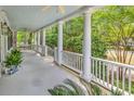 Inviting porch with classic columns and ample space for seating, ideal for enjoying the outdoors at 486 Lantana Circle, Georgetown, SC 29440