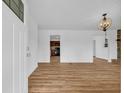 Bright living room boasts hardwood floors and an elegant chandelier for modern charm at 4880 Highway 378, Conway, SC 29527