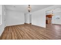 Open-concept living area featuring luxury vinyl flooring and a modern light fixture at 4880 Highway 378, Conway, SC 29527