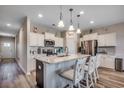 Bright kitchen with white cabinetry, stainless steel appliances, a granite countertop island, and stylish pendant lighting at 5077 Gladstone Dr, Conway, SC 29526