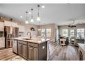 Open-concept kitchen featuring a large island, stainless steel appliances, and a seamless flow to the living area at 5077 Gladstone Dr, Conway, SC 29526