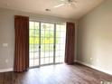 Bedroom featuring wood floors, a ceiling fan, and sliding glass doors to the balcony at 5825 Catalina Dr. # 234, North Myrtle Beach, SC 29582