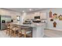 Modern kitchen with granite countertops, stainless steel appliances, and a breakfast bar with seating for four at 623 Fair Feather Ct., Myrtle Beach, SC 29588