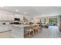 Bright open-concept kitchen with a large island and views of the living area and outdoor pool at 623 Fair Feather Ct., Myrtle Beach, SC 29588