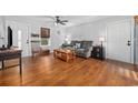Bright living room with hardwood floors, neutral paint, and cozy seating at 706 Birch Ln., Conway, SC 29526