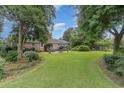 Expansive backyard featuring a well-maintained lawn and mature trees at 7607 Kingswood Dr., Myrtle Beach, SC 29572