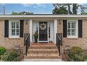 Elegant front entry with brick steps and decorative wreath on the door at 7607 Kingswood Dr., Myrtle Beach, SC 29572