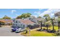 Charming townhouse exterior with ample parking, fenced patio area, and lush landscaping at 800 9Th Ave. S # A-4, North Myrtle Beach, SC 29582